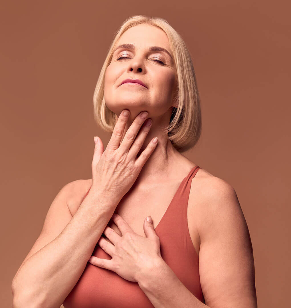 Mature woman touching her neck