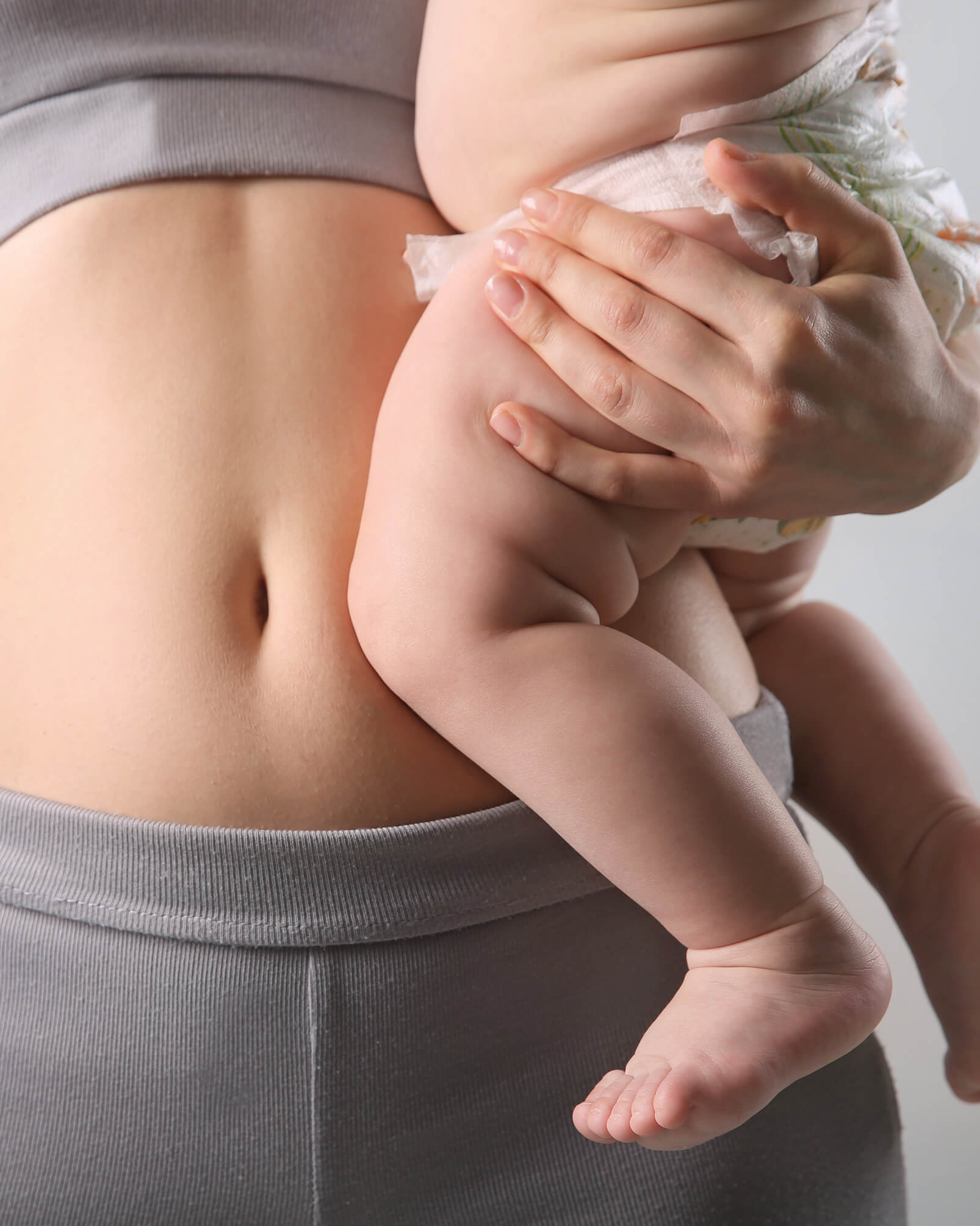 woman holding her child against her belly